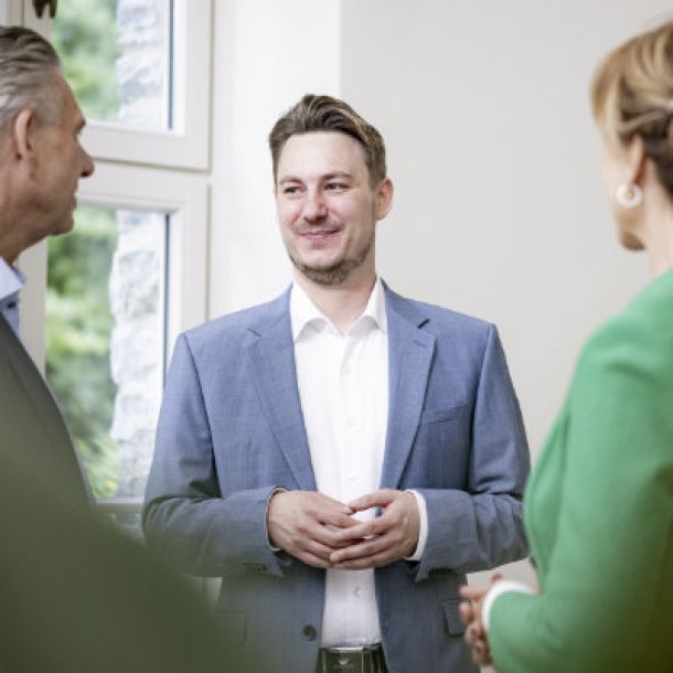 Drei Menschen diskutieren eine Grafik